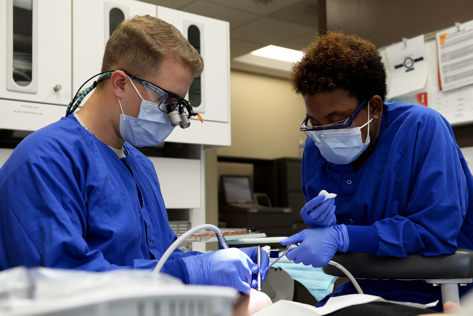 Capt. Travis Wagner, 14th Medical Operations Squadron general dentist, and Shaneka Hubbard, 14th MDOS dental assistant, operate on a patient Nov. 7, 2018, on Columbus Air Force Base, Mississippi. The Columbus AFB dental clinic works to keep the dental health of every patient in the best condition possible and is highly keen on aiding Airmen in the best preventative oral habits. (U.S. Air Force photo by Airman Hannah Bean)