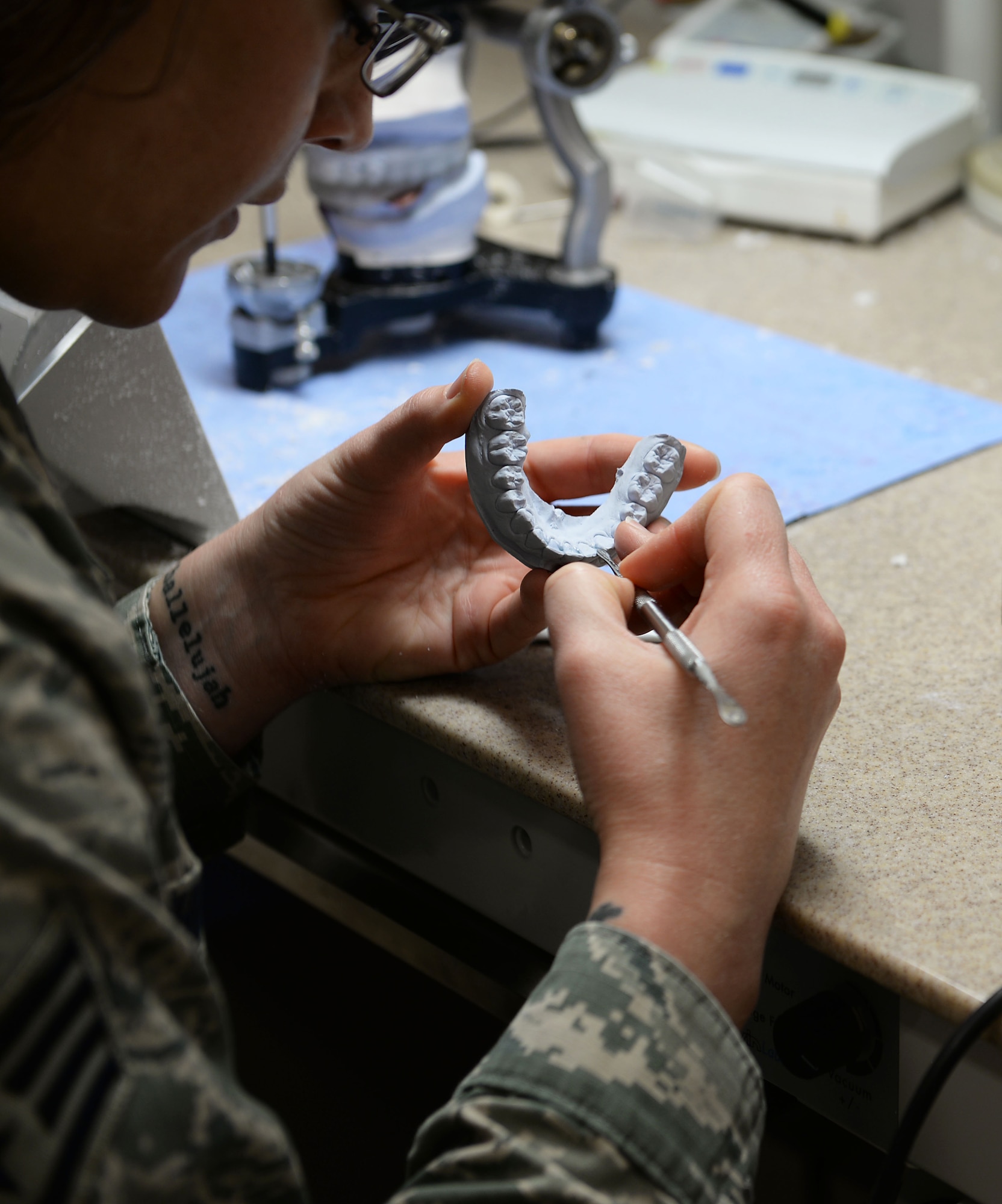 Staff Sgt. Maria Schinella, 14th Medical Operations Squadron dental laboratory technician, works on a patient’s mouth mold Nov. 7, 2018, on Columbus Air Force Base, Mississippi. The molds are used to fit a variety of prostheses including dentures, posts and implants. (U.S. Air Force photo by Airman Hannah Bean)