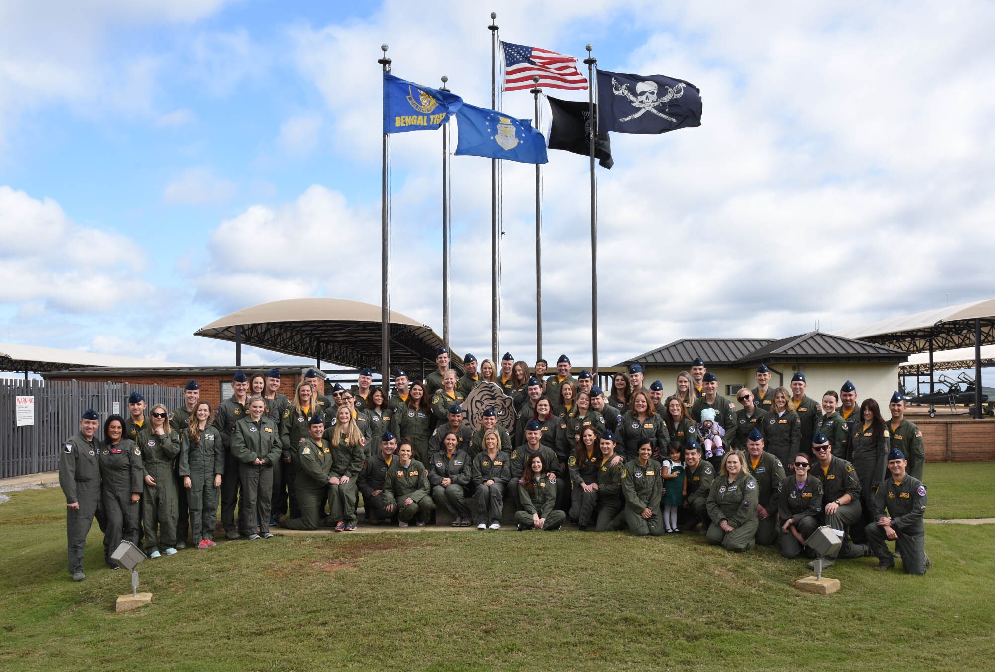 Many 37th Flying Training Squadron instructor pilots stand with their spouses Nov. 2, 2018, on Columbus Air Force Base, Mississippi. Spouse flights are annual for the 14th Operations group to thank spouses. Military spouses are next to uniformed members across the world, supporting the Air Force mission by supporting their Airmen. (U.S. Air Force photo by Elizabeth Owens)