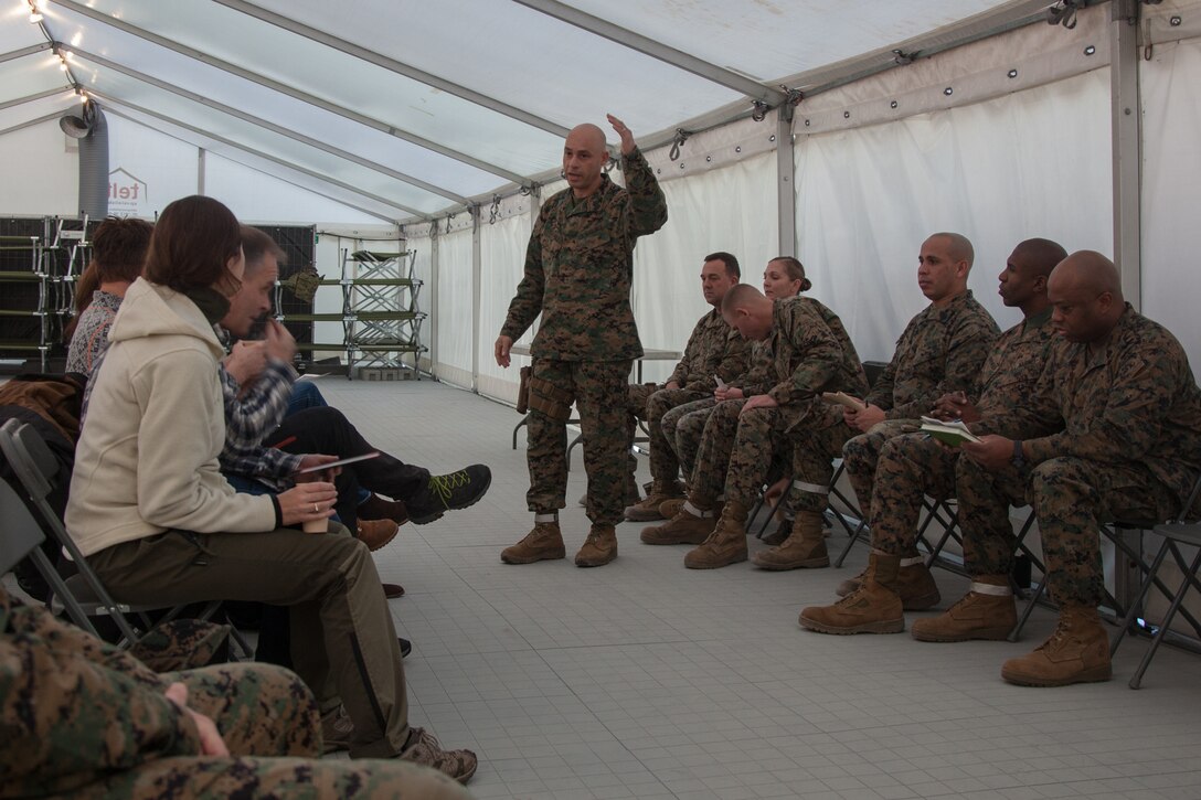 U.S. Marine Corps Sgt. Maj. Alex Narvaez, the sergeant major. of 2nd Marine Logistics Group-Forward (2nd MLG-Fwd), speaks to Norwegian military leaders in Stjødal, Norway, Nov. 5, 2018. Leaders of the Norwegian military met with leaders and noncommissioned officers (NCOs) of 2nd MLG-Fwd to discuss the role of the Marine Corps NCO during Exercise Trident Juncture 18. The exercise enhances the U.S. and NATO Allies’ and partners’ abilities to work together collectively to conduct military operations under challenging conditions. (U.S. Marine Corps photo by Lance Cpl. Scott R. Jenkins)