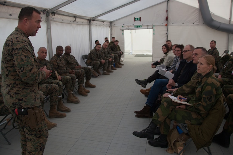 U.S. Marine Corps Master Gunnery Sgt. Dale Hardwood, with 2nd Marine Logistics Group-Forward (2nd MLG-Fwd), speaks to Norwegian military leaders in Stjørdal, Norway, Nov. 5, 2018. Leaders of the Norwegian military met with leaders and noncommissioned officers (NCOs) of 2nd MLG-Fwd to discuss the role of the Marine Corps NCO during Exercise Trident Juncture 18. The exercise enhances the U.S. and NATO Allies’ and partners’ abilities to work together collectively to conduct military operations under challenging conditions. (U.S. Marine Corps photo by Lance Cpl. Scott R. Jenkins)