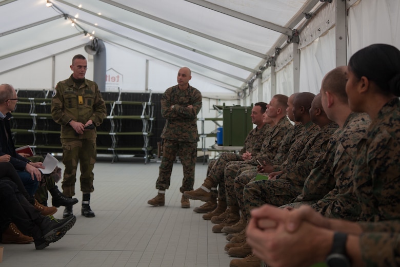 Norwegian Army Brig. Gen. Jon Morten Mangersens, right, the commander of the Norwegian Land Warfare Center, speaks with U.S. Marines from 2nd Marine Logistics Group-Forward (2nd MLG-Fwd) in Stjødal, Norway, Nov. 5, 2018. Leaders of the Norwegian military met with leaders and noncommissioned officers (NCOs) of 2nd MLG-Fwd to discuss the role of the Marine Corps NCO during Exercise Trident Juncture 18. The exercise enhances the U.S. and NATO Allies’ and partners’ abilities to work together collectively to conduct military operations under challenging conditions. (U.S. Marine Corps photo by Lance Cpl. Scott R. Jenkins)