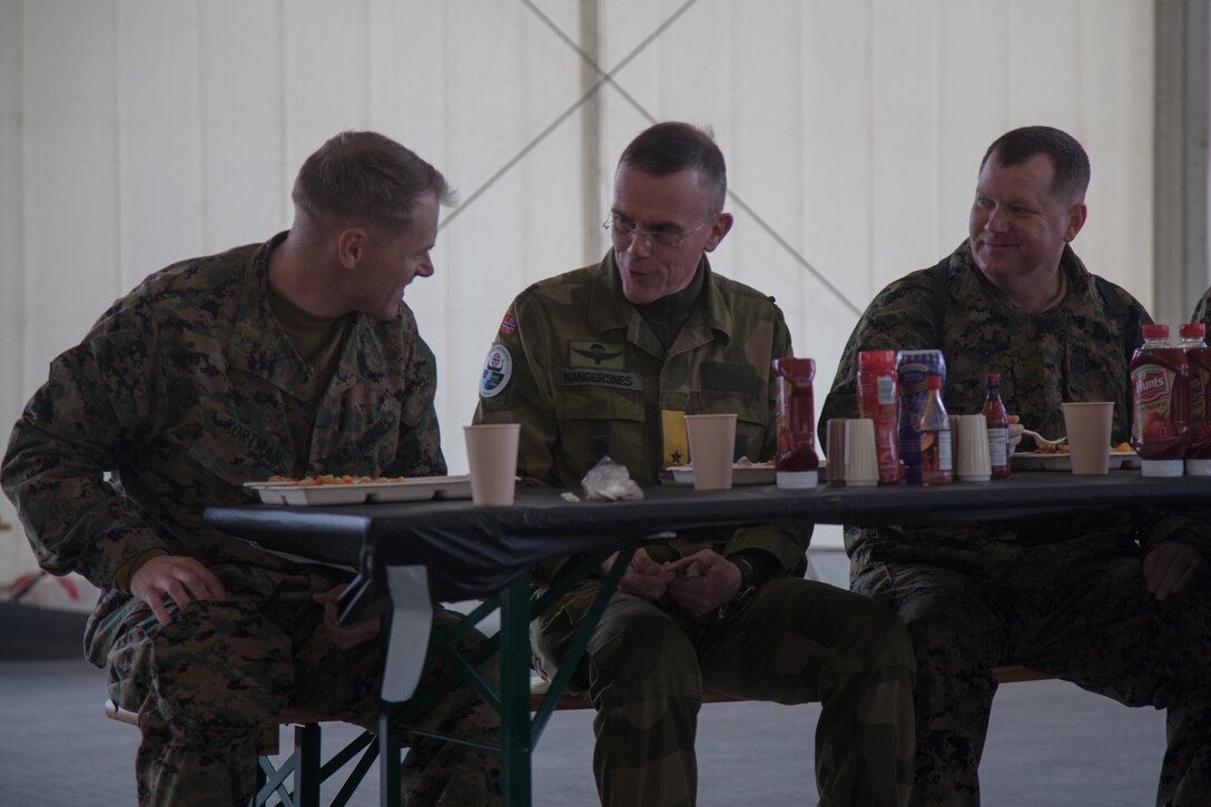 Norwegian Army Brig. Gen. Jon Morten Mangersnes, right, the commander of the Norwegian Land Warfare Center, speaks with  Maj. Duane Kortman Jr., left, and Master Gunnery Sgt. William Jansen, both with 2nd Marine Logistics Group-Forward (2nd MLG-Fwd), in Stjødal, Norway,Nov. 5, 2018. Leaders of the Norwegian military met with leaders and noncommissioned officers (NCOs) of 2nd MLG-Fwd to discuss the role of the Marine Corps NCO during Exercise Trident Juncture 18. The exercise enhances the U.S. and NATO Allies’ and partners’ abilities to work together collectively to conduct military operations under challenging conditions. (U.S. Marine Corps photo by Lance Cpl. Scott R. Jenkins)