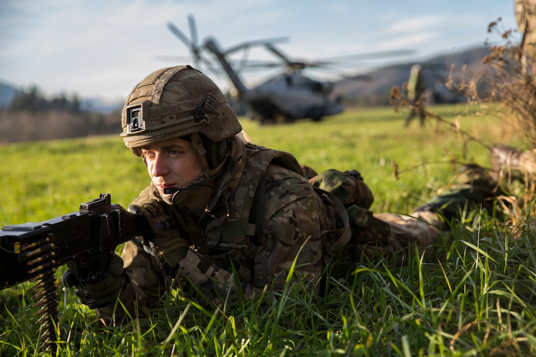 A British Royal Marine provides security after disembarking a U.S. Marine Corps CH-53E Super Stallion during a Tactical Recovery of Aircraft and Personnel (TRAP) exercise in Rindal, Norway, Nov. 6, 2018. The Royal Marines with X-Ray Company, 45 Commando, worked in conjunction with the 24th Marine Expeditionary Unit and assets from Marine Aircraft Group 29 to increase their TRAP proficiency and bilateral interoperability during Exercise Trident Juncture 18. The exercise enhances the U.S. and NATO Allies’ and partners’ abilities to work together collectively to conduct military operations under challenging conditions. (U.S. Marine Corps photo by Cpl. Margaret Gale)