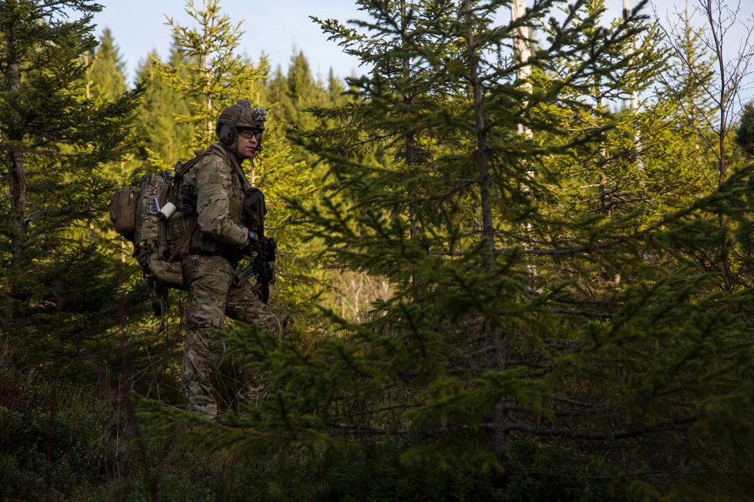 A British Royal Marine searches for a simulated isolated service member during a Tactical Recovery of Aircraft and Personnel (TRAP) exercise in Rindal, Norway, Nov. 6, 2018. The Royal Marines with X-Ray Company, 45 Commando, worked in conjunction with the 24th Marine Expeditionary Unit and assets from Marine Aircraft Group 29 to exercise their TRAP proficiency and bilateral interoperability during Exercise Trident Juncture 18. The exercise enhances the U.S. and NATO Allies’ and partners’ abilities to work together collectively to conduct military operations under challenging conditions. (U.S. Marine Corps photo by Cpl. Margaret Gale)