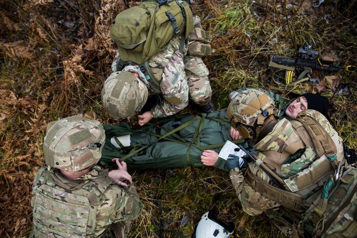 British Royal Marines prepare to evacuate Capt. Josef Otmar during a Tactical Recovery of Aircraft and Personnel (TRAP) exercise in Rindal, Norway, Nov. 6, 2018. The Royal Marines with X-Ray Company, 45 Commando, worked in conjunction with the 24th Marine Expeditionary Unit and assets from Marine Aircraft Group 29 to exercise their TRAP proficiency and bilateral interoperability during Exercise Trident Juncture 18. Otmar is a pilot with Marine Heavy Helicopter Squadron 366 and was playing the role of an isolated and injured service member. The exercise enhances the U.S. and NATO Allies’ and partners’ abilities to work together collectively to conduct military operations under challenging conditions. (U.S. Marine Corps photo by Cpl. Margaret Gale)