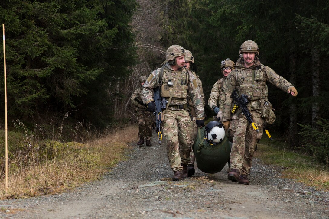 British Royal Marines evacuate Capt. Josef Otmar during a Tactical Recovery of Aircraft and Personnel (TRAP) exercise in Rindal, Norway, Nov. 6, 2018. The Royal Marines with X-Ray Company, 45 Commando, worked in conjunction with the 24th Marine Expeditionary Unit and assets from Marine Aircraft Group 29 to exercise their TRAP proficiency and bilateral interoperability during Exercise Trident Juncture 18. Otmar is a pilot with Marine Heavy Helicopter Squadron 366 and was playing the role of an isolated and injured service member. The exercise enhances the U.S. and NATO Allies’ and partners’ abilities to work together collectively to conduct military operations under challenging conditions. (U.S. Marine Corps photo by Cpl. Margaret Gale)