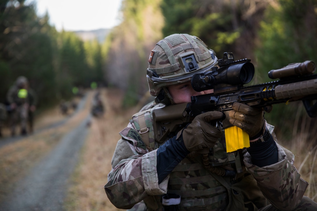 A British Royal Marine provides security while searching for a simulated isolated service member during a Tactical Recovery of Aircraft and Personnel (TRAP) exercise,in Rindal, Norway, Nov. 6, 2018. The Royal Marines, with X-Ray Company, 45 Commando, worked in conjunction with the 24th Marine Expeditionary Unit and assets from Marine Aircraft Group 29 to exercise their tactical recovery of aircraft and personnel proficiency and bilateral interoperability during Trident Juncture 18. The exercise enhances the U.S. and NATO Allies’ and partners’ abilities to work together collectively to conduct military operations under challenging conditions. (U.S. Marine Corps photo by Cpl. Margaret Gale)