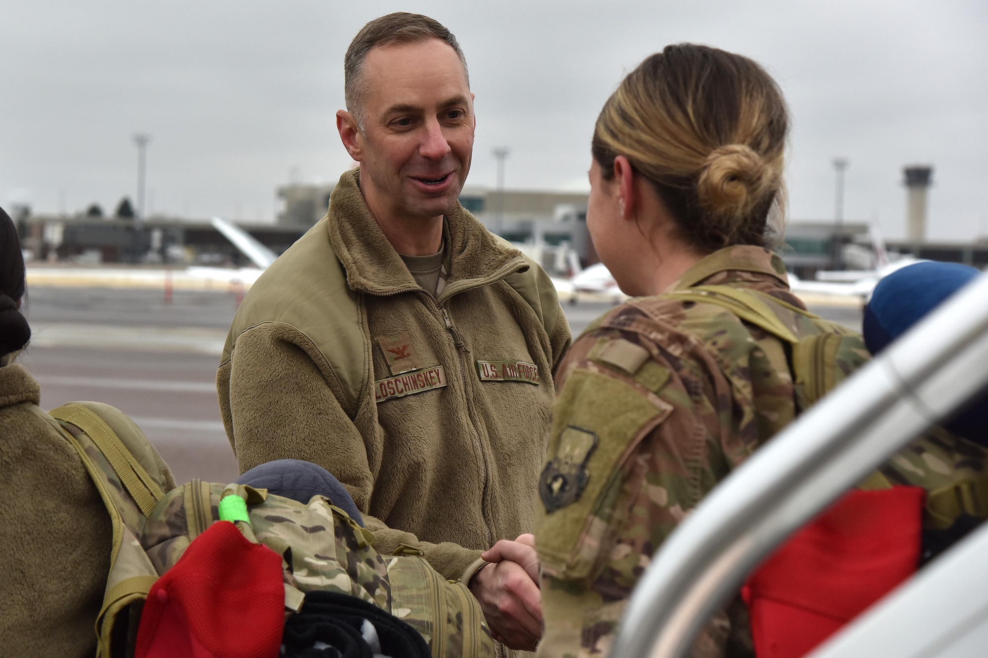 Col. Jason Loschinskey, 819th Rapid Engineer Deployable Heavy Operational Repair Squadron Engineers (RED HORSE) commander, greets Airmen as they return from deployment Nov. 5, 2018, at Great Falls International Airport, Mont. More than 150 RED HORSE Airmen returned from deployment between the last week of October and first week of November. (U.S. Air Force photo by Airman 1st Class Jacob M. Thompson)