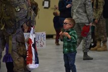 A child watches as his father approaches after returning home from deployment Nov. 5, 2018, at the airfields located on Malmstrom Air Force Base, Mont. RED HORSE Airmen returned home to friends and family after being deployed for approximately seven months. (U.S. Air Force photo by Airman 1st Class Jacob M. Thompson)