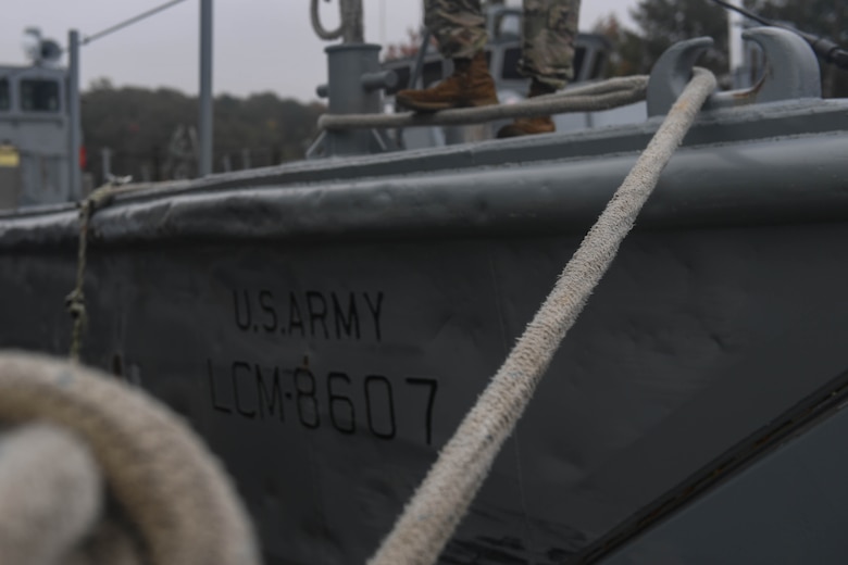 A U.S. Army Soldier assigned to the 73rd Transportation Company, 10th Trans. Battalion, 7th Trans. Brigade (Expeditionary), waits for a Landing Craft Mechanized, Mark 8 during towing training at Joint Base Langley-Eustis, Virginia, Nov. 5, 2018. The 73rd Trans. Co. uses one 900-series Small Tug to perform installation support operations at the inner harbor while the other is used for brigade taskings and Maritime and Intermodal Training Department field training exercises. (U.S. Air Force photo by Senior Airman Derek Seifert)