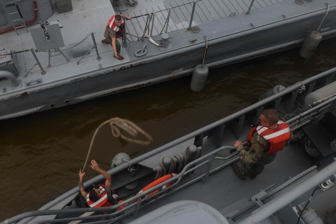 U.S. Army Soldiers secure a Landing Craft Mechanized, Mark 8 to a 900-series Small Tug during towing training at Joint Base Langley-Eustis, Virginia, Nov. 5, 2018. Depending on the type of tow the Small Tug crew determines to use, the vessel can be towed from the front or rear, which creates challenges for the vessel master when steering. (U.S. Air Force photo by Senior Airman Derek Seifert)