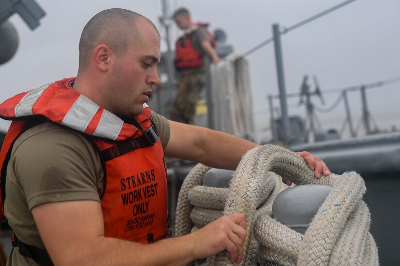 U.S. Army Soldier Pfc. Philip Shannon, 73rd Transportation Company, 10th Trans. Battalion, 7th Trans. Brigade (Expeditionary) seaman, secures rope to a 900-series Small Tug at Joint Base Langley-Eustis, Virginia, Nov. 5, 2018. Before parking the vessel, the Soldiers of the 73rd Trans. Co. secure all tow lines to the Small Tug to prevent a potential hazardous working environment. (U.S. Air Force photo by Senior Airman Derek Seifert)