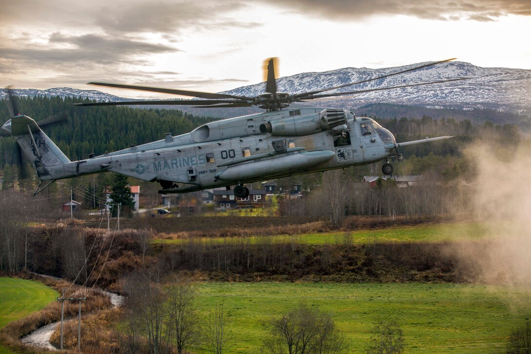 A helicopter takes off in the Norwegian countryside.