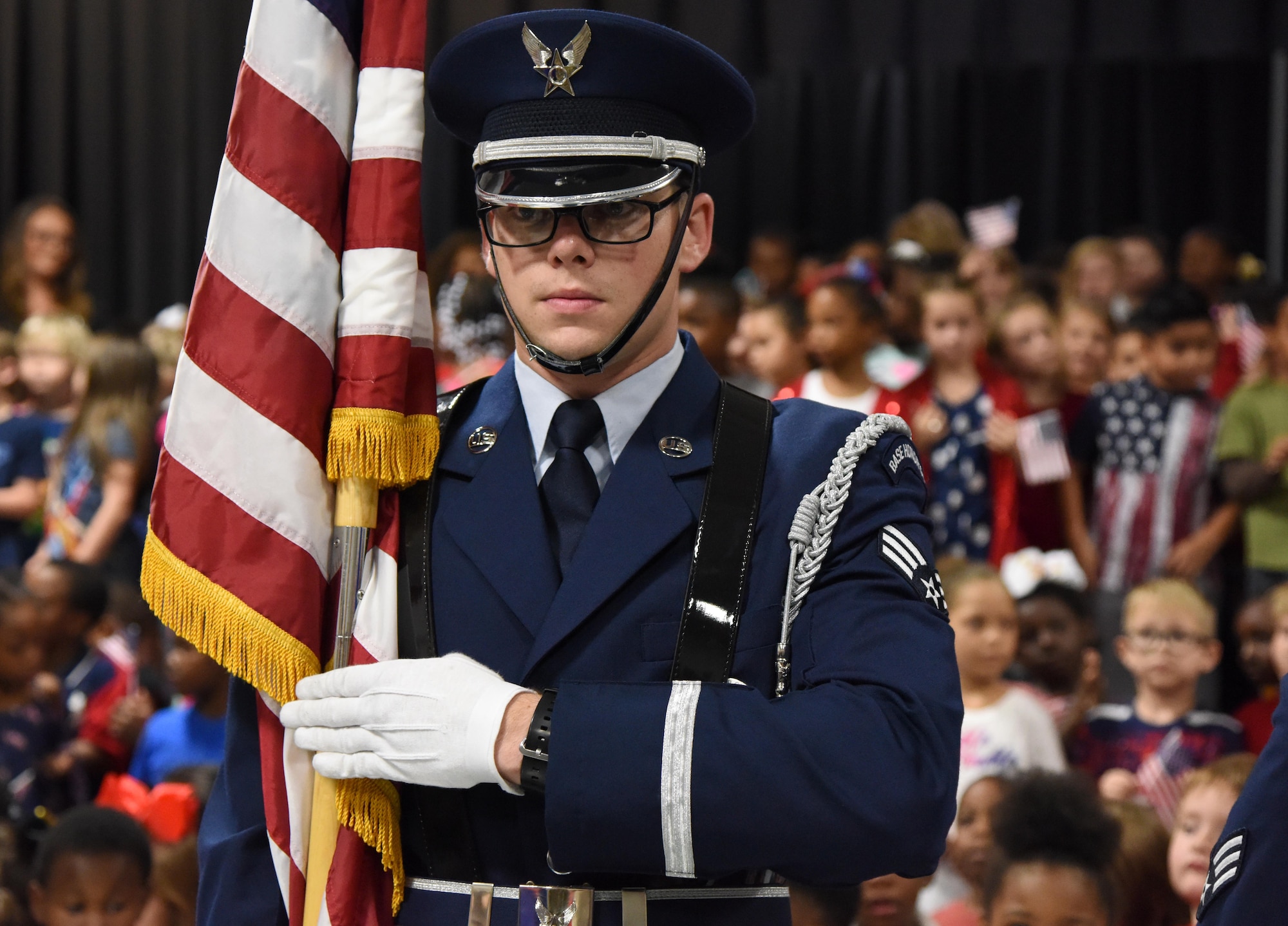 U.S. Air Force Senior Airman Fredrick Taylor, Keesler Honor Guard member, presents the colors during the Jeff Davis Elementary School Veterans Day celebration in Biloxi, Mississippi, Nov. 8, 2018. During the event, students recited the Pledge of Allegiance and sang several patriotic songs. Keesler Air Force Base leadership, honor guardsmen and base personnel attended the event. (U.S. Air Force photo by Kemberly Groue)