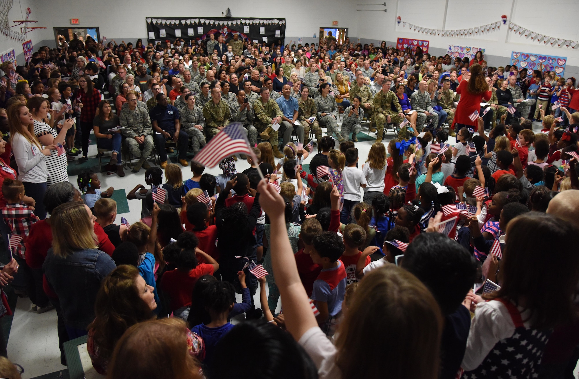 Keesler Air Force Base personnel and family members attend the Jeff Davis Elementary School Veterans Day celebration in Biloxi, Mississippi, Nov. 8, 2018. During the event, students recited the Pledge of Allegiance and sang several patriotic songs. Keesler Air Force Base leadership, honor guardsmen and base personnel attended the event. (U.S. Air Force photo by Kemberly Groue)