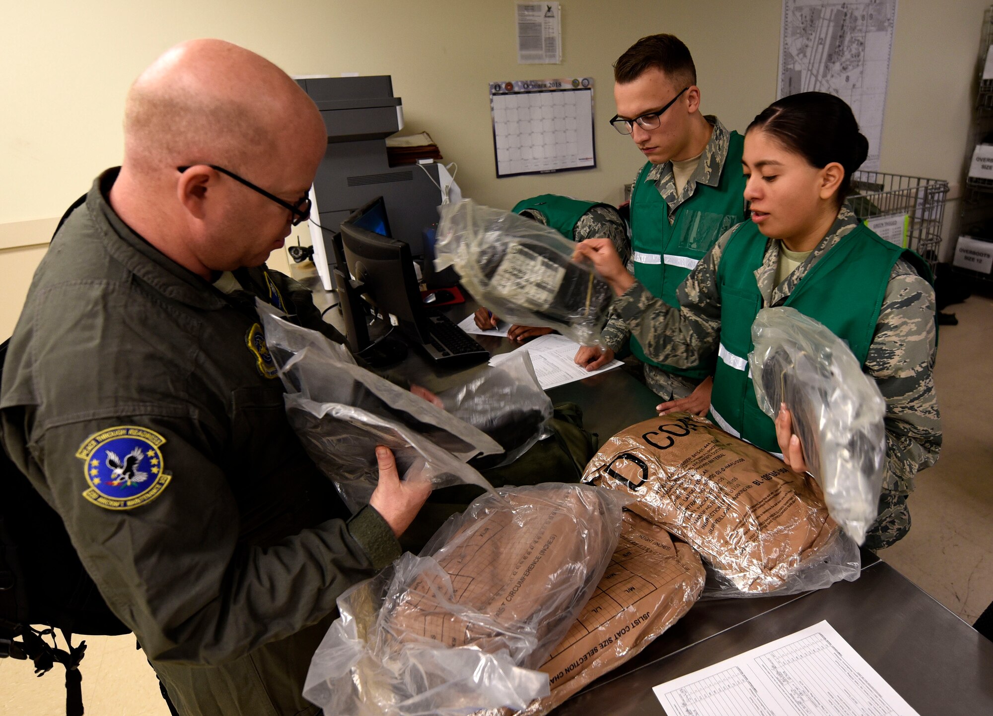 Airmen from the 22nd Logistics Readiness Squadron review mobility items prior to issuing the equipment during Global Thunder 19, Oct. 31, 2018, at McConnell Air Force Base, Kan. This process ensures Airmen have all of the required items if deploying in support of a contingency. The Global Thunder exercise provides training opportunities that assess all U.S. Strategic Command (USSTRATCOM) mission areas and joint and field training operational readiness, with a specific focus on nuclear readiness. It globally integrates USSTRATCOM headquarters staff, components and subordinate units, and allied personnel from a variety of nations to test readiness and ensure a safe, secure, ready and reliable strategic deterrent force. (U.S. Air Force photo by Airman 1st Class Michaela R. Slanchik)