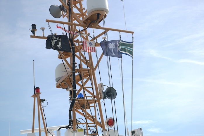 Flags blow in the wind atop the U.S. Coast Guard Cutter Cormorant Nov. 7, 2018 in Charleston, S.C. The ship’s crew took the USCG Academy class of 1965 on a tour of the Charleston Harbor during the 50-year anniversary of when they deployed to Vietnam. The class was deployed to Vietnam in 1968 where they patrolled the coast of the country during the conflict.