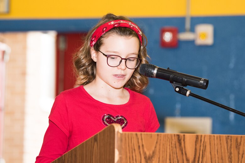 Laura Fenush, 7th grader and Patriot’s Pen youth essay finalist speaks at a Veterans Day celebration Nov. 9, 2018, at Dover Air Force Base Middle School, Dover Air Force Base, Del. Patriot’s Pen is a youth essay contest for students sponsored by the Veterans of Foreign Wars. (U.S. Air Force photo by Mauricio Campino)
