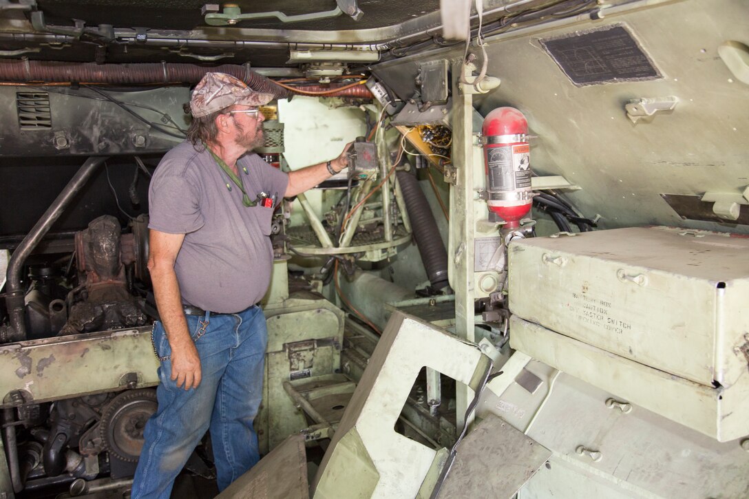 Ronald Arnoldy, electronics mechanic, Communications Shop, prepares to remove an intercom box for repair from an Amphibous Assault Vehicle at Production Plant Barstow, Marine Depot Mainteinance Command, aboard the Yermo Annex of Marine Corps Logistics Base Barstow, Calif., Nov. 1. Arnoldy has worked for PPB for more than 30 years. He is a 20-year veteran of the Marine Corps who retired as a gunnery sergeant and began work for the Plant the next month.