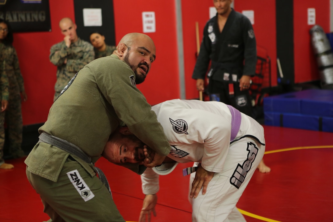 Sean Ruiz, a professor with Carlson Gracie Brazilian Jiu-Jitsu, instructs a holding technique during a submission seminar at the High Intensity Tactical Training center on Marine Corps Air Station Miramar, Calif., Nov. 8. Carlson Gracie Brazilian Jiu-Jitsu hosted an advanced submission class and seminar on power resiliency for Marines stationed at MCAS Miramar to boost confidence and improve self-defense skills. (U.S. Marine Corps photo by Sgt. Daniel Auvert.)