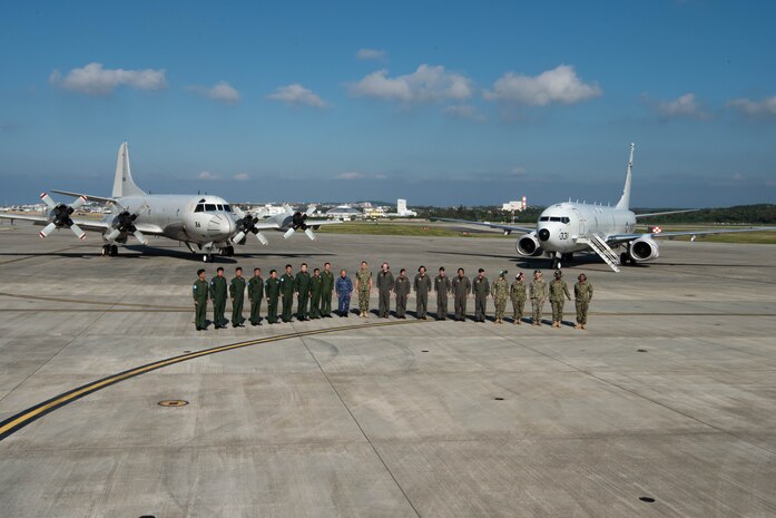 U.S. Navy Adm. Phil Davidson, commander of U.S. Indo-Pacific Command, and Joint Japan Staff Adm. Katsutoshi Kawano, Chief of Staff, pose for a photo with aircrews at Kadena Air Base Nov. 7, 2018.