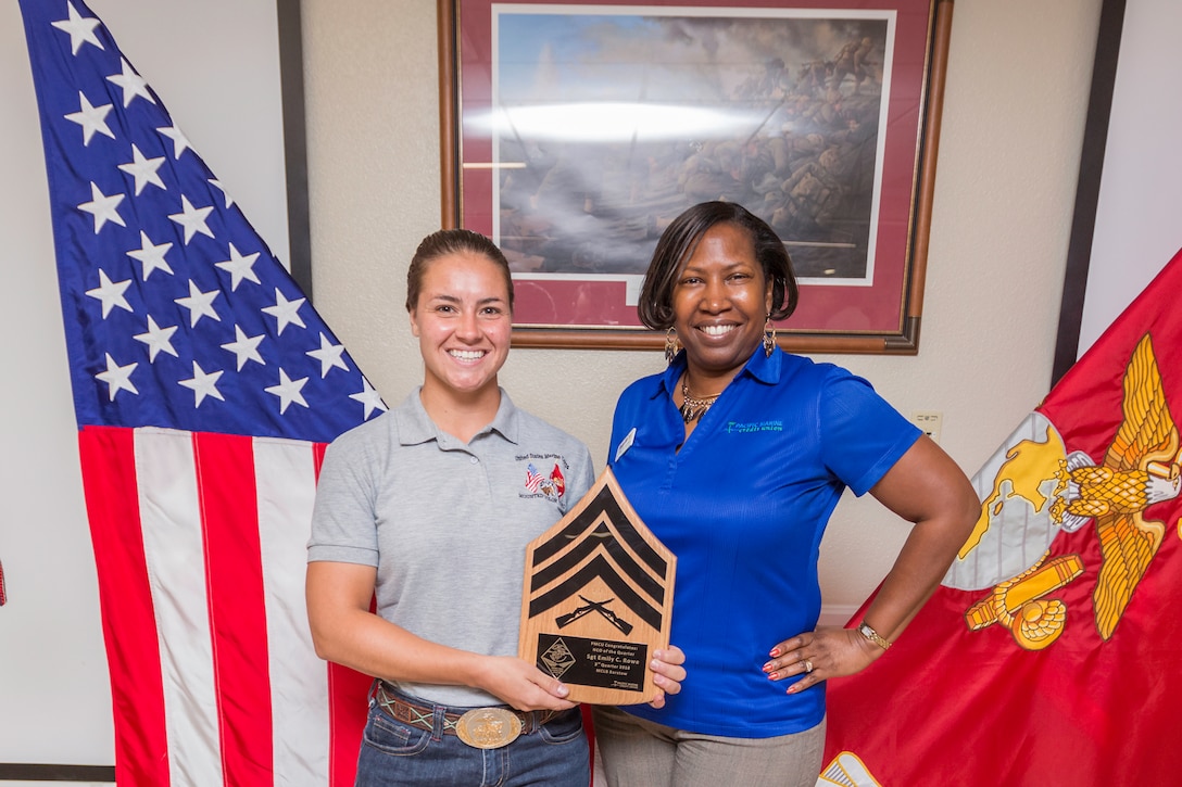 Sergeant Emily Rowe, Mounted Color Guard Horseman, receives the NCO of the Quarter award for the third quarter from Stacey McCray, Pacific Marine Credit Union, during the Quarterly Awards Breakfast aboard Marine Corps Logistics Base Barstow, Calif., Oct. 30.