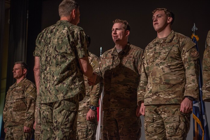 U.S. Navy Adm. Phil Davidson, commander of U.S. Indo-Pacific Commad, presents awards to members of the 353rd Special Operations Group who directly assisted in the recent rescue of a Thai children's soccer team, at Kadena Air Base Nov. 9, 2018.