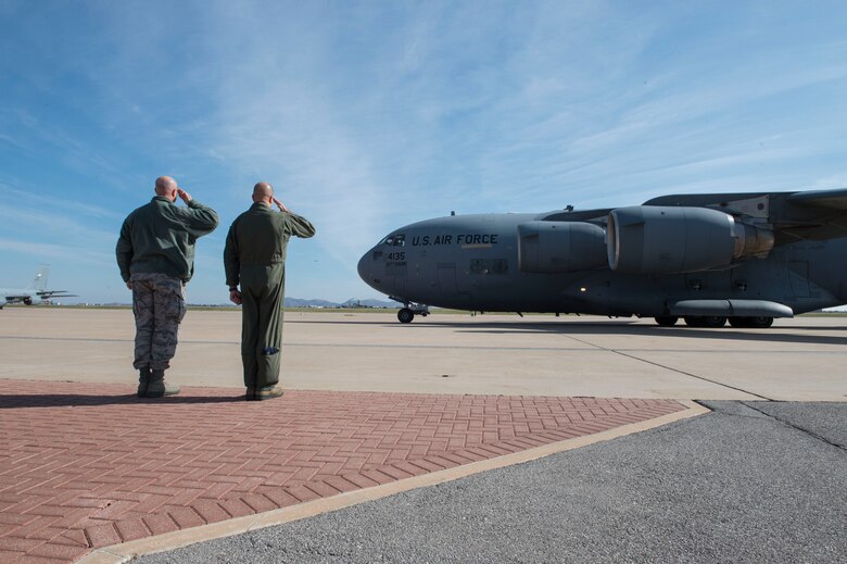 U.S. Air Force Chief Master Sgt. Randy Kay II, 97th Air Mobility Wing command chief and Col. Eric Carney, 97th Air Mobility Wing commander, render a farewell salute to Maj. Gen. Mark Weatherington, Air Education and Training Command deputy commander, Nov. 8, 2018, at Altus Air Force Base, Okla. Weatherington spent two days seeing the mission of the men and women of the Mighty 97th. (U.S. Air Force photo by Senior Airman Cody Dowell)