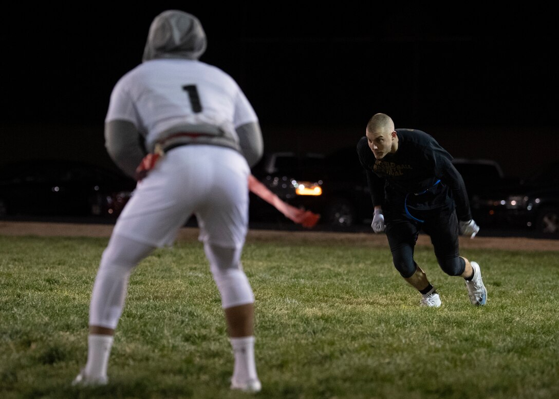 Airman 1st Class Daniel Gilroy, SF Stank wide receiver, sprints during his route while guarded by Senior Airman Shaun Sykes, SF Sykes cornerback, during the 2018 intramural flag football championship at Kirtland Air Force Base, N.M., Nov. 8. (U.S. Air Force photo by Staff Sgt. J.D. Strong II)