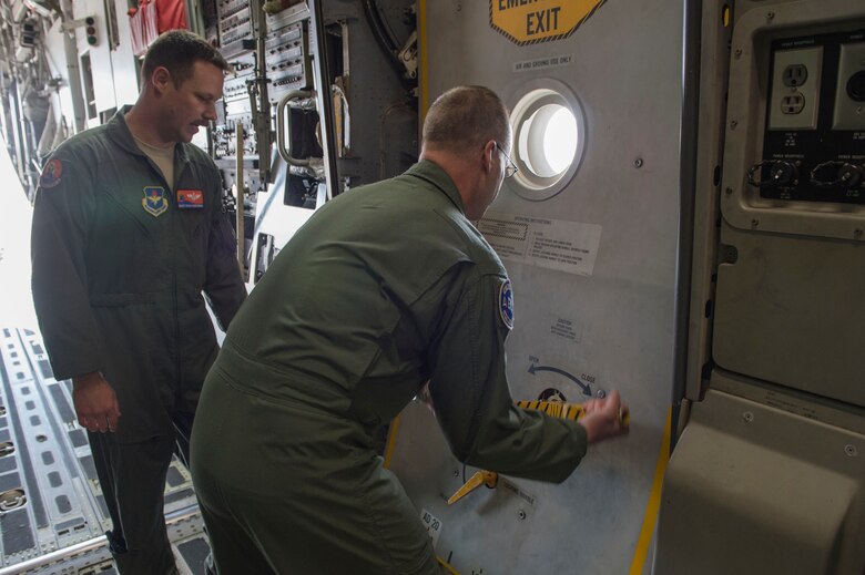 U.S. Air Force Maj. Gen. Mark Weatherington, Air Education and Training Command deputy commander, opens one of the exits on a C-17 Globemaster III, Nov. 8, 2018, at Altus Air Force Base, Okla. The 97th LRS showcased loading cargo onto a C-17, which was part of the Weatherington’s tour of the bases capabilities. (U.S. Air Force photo by Senior Airman Cody Dowell)