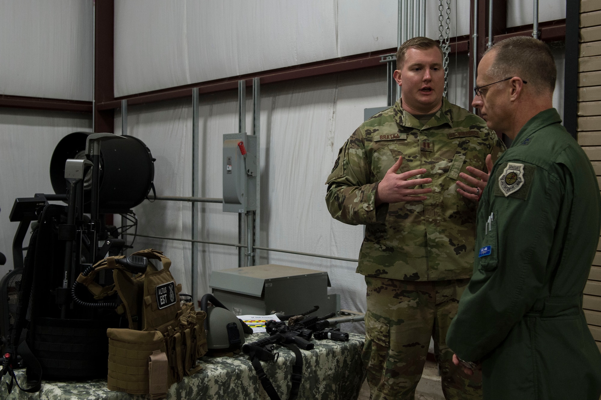 U.S. Air Force Capt. Nathan Bratka, operations officer assigned to the 97th Security Forces Squadron, showcases the equipment used by the emergency service team for the 97th SFS to Maj. Gen. Mark Weatherington, Air Education and Training Command deputy commander, Nov. 8, 2018, at Altus Air Force Base, Okla. Several squadrons across the 97th Air Mobility Wing showcased their capabilities to Weatherington to highlight their innovations and progress with training. (U.S. Air Force photo by Senior Airman Cody Dowell)
