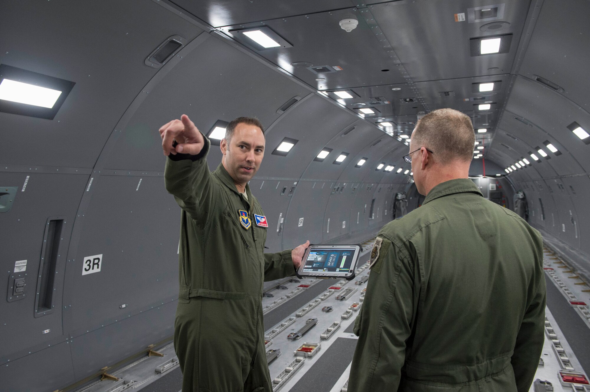 U.S. Air Force Tech. Sgt. Dustan Foret, NCO in charge of the KC-46 Pegasus aircrew training systems assigned the 97th Training Squadron, shows Maj. Gen. Mark Weatherington, Air Education and Training Command deputy commander, the inner workings of the KC-46 Fuselage Trainer, Nov. 8, 2018, at Altus Air Force Base, Okla. The fuselage was part of the tour for Weatherington to see the capabilities that the base has for the arrival of the KC-46 aircraft. (U.S. Air Force photo by Senior Airman Cody Dowell)