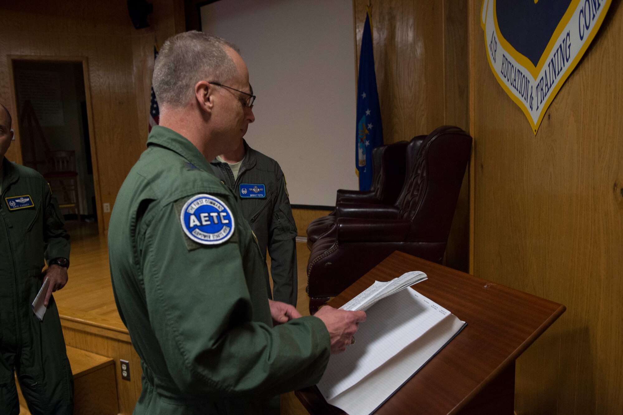 U.S. Air Force Maj. Gen. Mark Weatherington, Air Education and Training Command deputy commander, looks through the boom operator heritage book, Nov. 8, 2018, at Altus Air Force Base, Okla. The book contains the signatures of boom operators that have graduated from the formal training unit. (U.S. Air Force photo by Senior Airman Cody Dowell)