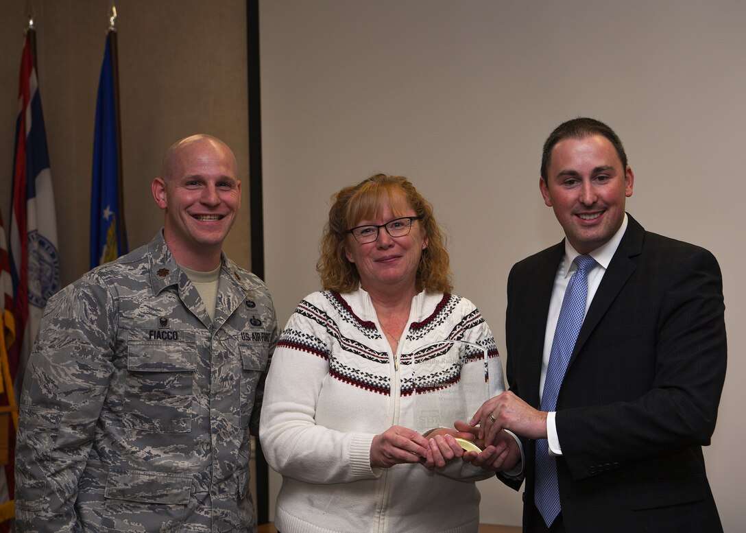Award winner Sandra Rutherford, 90th Contracting Squadron director of business operations, is presented the Small Business Advocate of the Year award for the State of Wyoming, Nov. 7, 2018, at F.E. Warren Air Force Base, Wyo. The award recognizes individuals who have provided exceptional services to small businesses. Rutherford sought out opportunities and ensured openings were offered to women and veteran owned firms and small businesses. (U.S. Air Force photo by Senior Airman Ashley N. Sokolov)