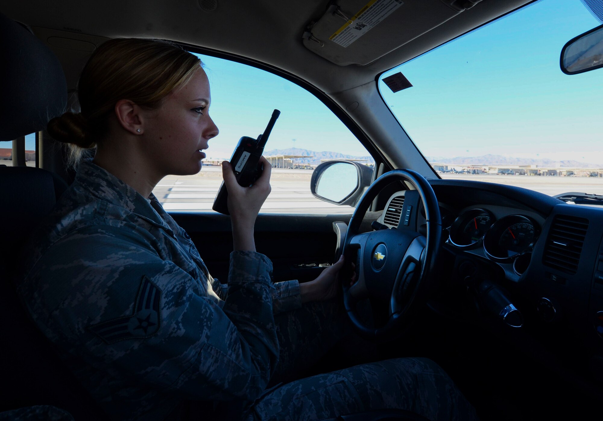 Senior Airman Sierra Rodwick, 57th Operations Support Squadron airfield management shift lead, using a radio to contact the Air Traffic Control Tower Oct. 15, 2018 on Nellis Air Force Base, Nevada. The main responsibility of airfield management shift leads is ensuring the flightline’s safety. (U.S. Air Force photo by Airman Bailee A. Darbasie)