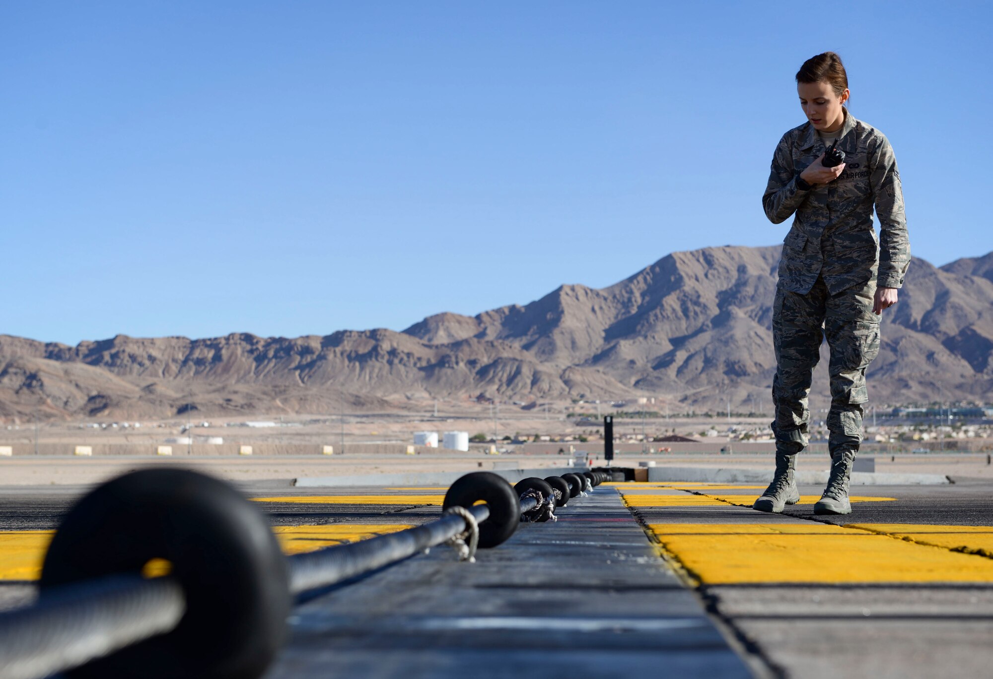 Airman 1st Class Allyson Estrada, 57th Operations Support Squadron airfield management shift lead, inspects a runway barrier Oct. 15, 2018 on Nellis Air Force Base, Nevada. Airfield management shift leads are required to complete multiple inspections per day. (U.S. Air Force photo by Airman Bailee A. Darbasie)