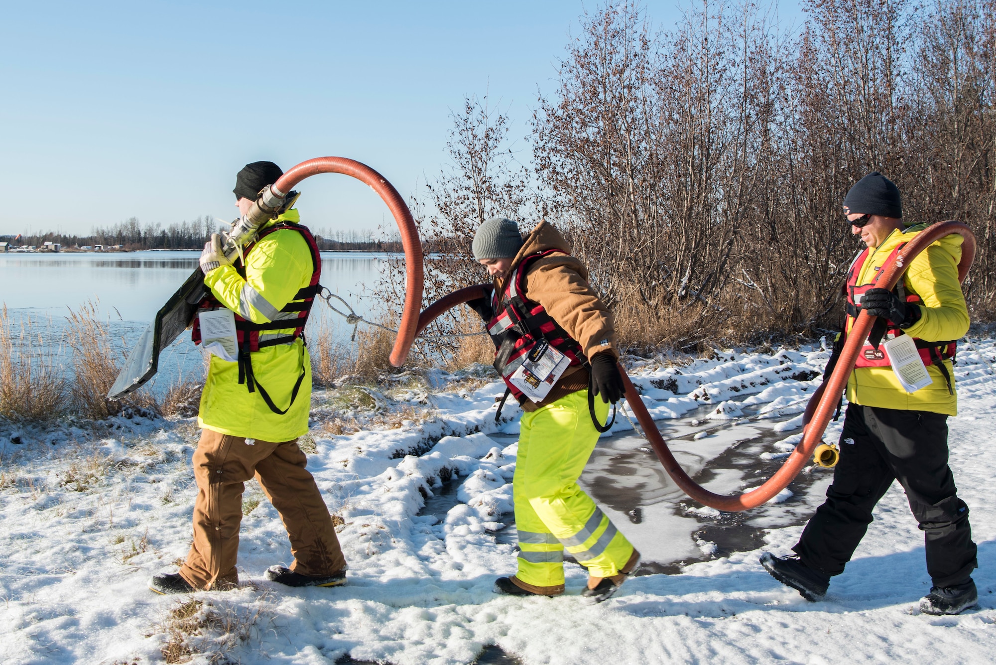 Airmen with the 611th Civil Engineer Squadron carry a skimmer to the annual Fall Spill Drill at Joint Base Elmendorf-Richardson, Alaska, Oct. 30, 2018. The exercise was conducted to test the response actions of base recovery agencies in the event of a mass fuel spill, to ensure installation safety and minimal environmental impact.