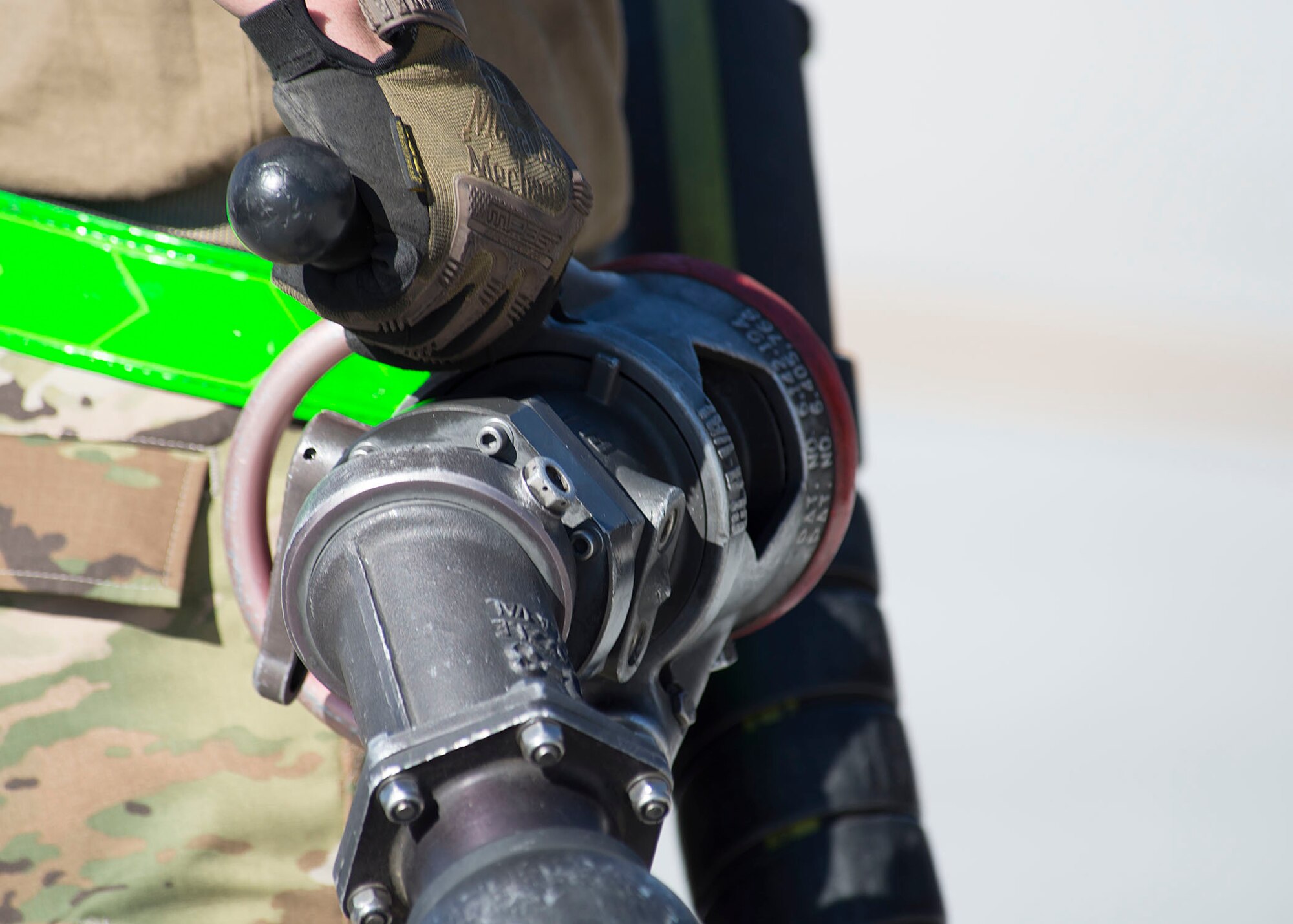 Airman 1st Class Joseph Main, 99th Logistics Readiness Squadron fuels distribution operator, holds a fuel hose on Nellis Air Force Base, Nevada, Nov. 7, 2018. This was Main’s first hot-pit refueling after arriving to Nellis around a year ago. (U.S. Air Force photo by Airman 1st Class Bryan T. Guthrie)