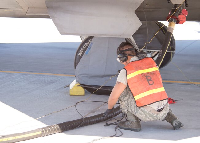 Senior Airman Johnny Cruz, 57th Aircraft Maintenance Squadron Raptor Aircraft Maintenance Unit assistant dedicated crew chief, looks over the fuel line on Nellis Air Force Base, Nevada, Nov. 7, 2018. Refueling times can be reduced significantly when the aircraft keeps their engines on. (U.S. Air Force photo by Airman 1st Class Bryan T. Guthrie)