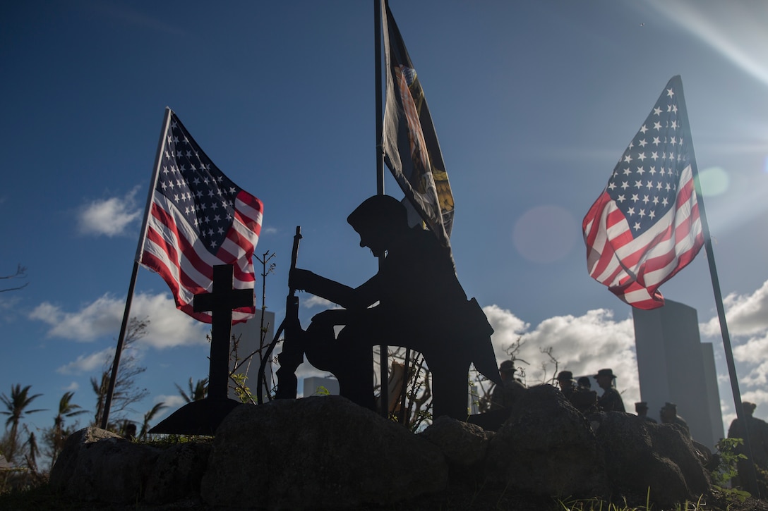 A cutout silhouette stands at the Veteran’s memorial park during the 31st Marine Expeditionary Unit and Combat Logistics Battalion 31 243 Marine Corps Birthday ceremony on Tinian, Commonwealth of the Northern Mariana Islands, Nov. 10, 2018. All the Marines taking part in the relief efforts here in the wake of Super Typhoon Yutu missed the traditional Marine Corps Birthday Ball in Okinawa, Japan, where both the 31st MEU and CLB-31 are garrisoned – improvising as Marines often do, the Marines and Sailors here pitched-in to coordinate a short ceremony which included a guest speaker, remarks from the commanding officer, a cake-cutting and gourmet dinner of hamburgers, hotdogs and a slice of cake. Marines and Sailors with the 31st MEU and CLB-31 are assisting local and civil authorities on Tinian to deliver aid for families affected by Super Typhoon Yutu, which struck here Oct. 25 as the second strongest storm to ever hit U.S. soil. Marines and Sailors with the 31st MEU and CLB-31 arrived on Tinian Oct. 29-31 to lead relief efforts on Tinian in response to Yutu as part of Task Force-West. TF-W is leading the Department of Defense’s efforts to assist CNMI’s local and civil authorities provide critical assistance for citizens devastated by Yutu. The 31st MEU, the Marine Corps’ only continuously forward-deployed MEU, provides a flexible force ready to perform a wide-range of military operations across the Indo-Pacific region.