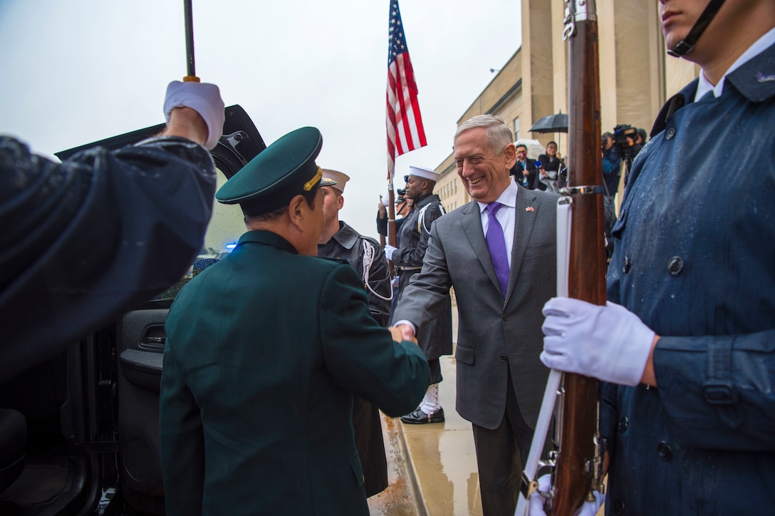 Defense Secretary James N. Mattis stands on the Pentagon steps and shakes hands with  Chinese Defense Minister Gen. Wei Fenghe.