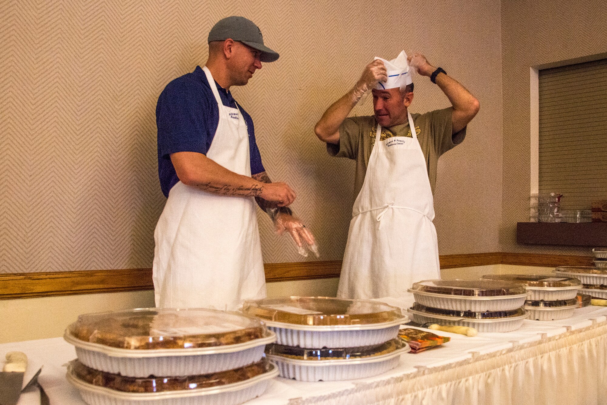 Master Sgt. Jason Meuse, 377th Logistics Readiness Squadron First Sergeant, and 58th Special Operations Wing Command Chief Master Sgt. Daniel Weimer prepare to serve a Thanksgiving luncheon Oct. 10 at the Mountain View Club. This lunchoen in years past was the traditional event scheduled for the families of deployed members, but was opened this year to the rest of Team Kirtland to increase support for deployed families. Patrons were treated to a traditional Thanksgiving lunch followed by entertainment from Tall Paul the Magician. (U.S. Air Force photo by Jim Fisher)