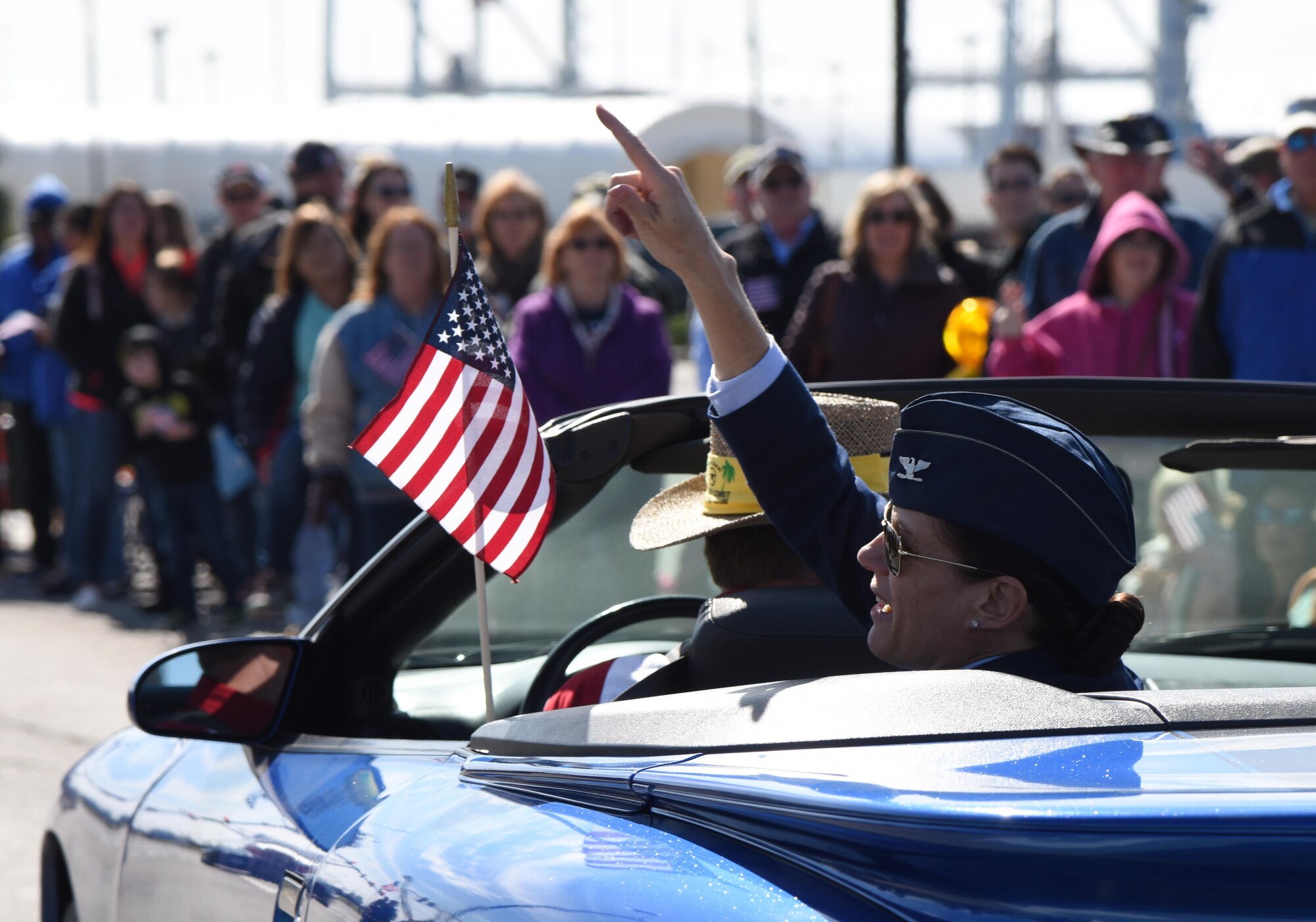 U.S. Air Force Col. Marcia Quigley, 81st Mission Support Group commander, tosses doubloons to the crowd during the 18th Annual Gulf Coast Veterans Day Parade in Gulfport, Mississippi, Nov. 10, 2018. Keesler Air Force Base leadership along with hundreds of Airmen attended and participated in the parade in support of all veterans past and present. More than 70 unique floats, marching bands and military units marched in the largest Veterans Day parade on the Gulf Coast. (U.S. Air Force photo by Kemberly Groue)