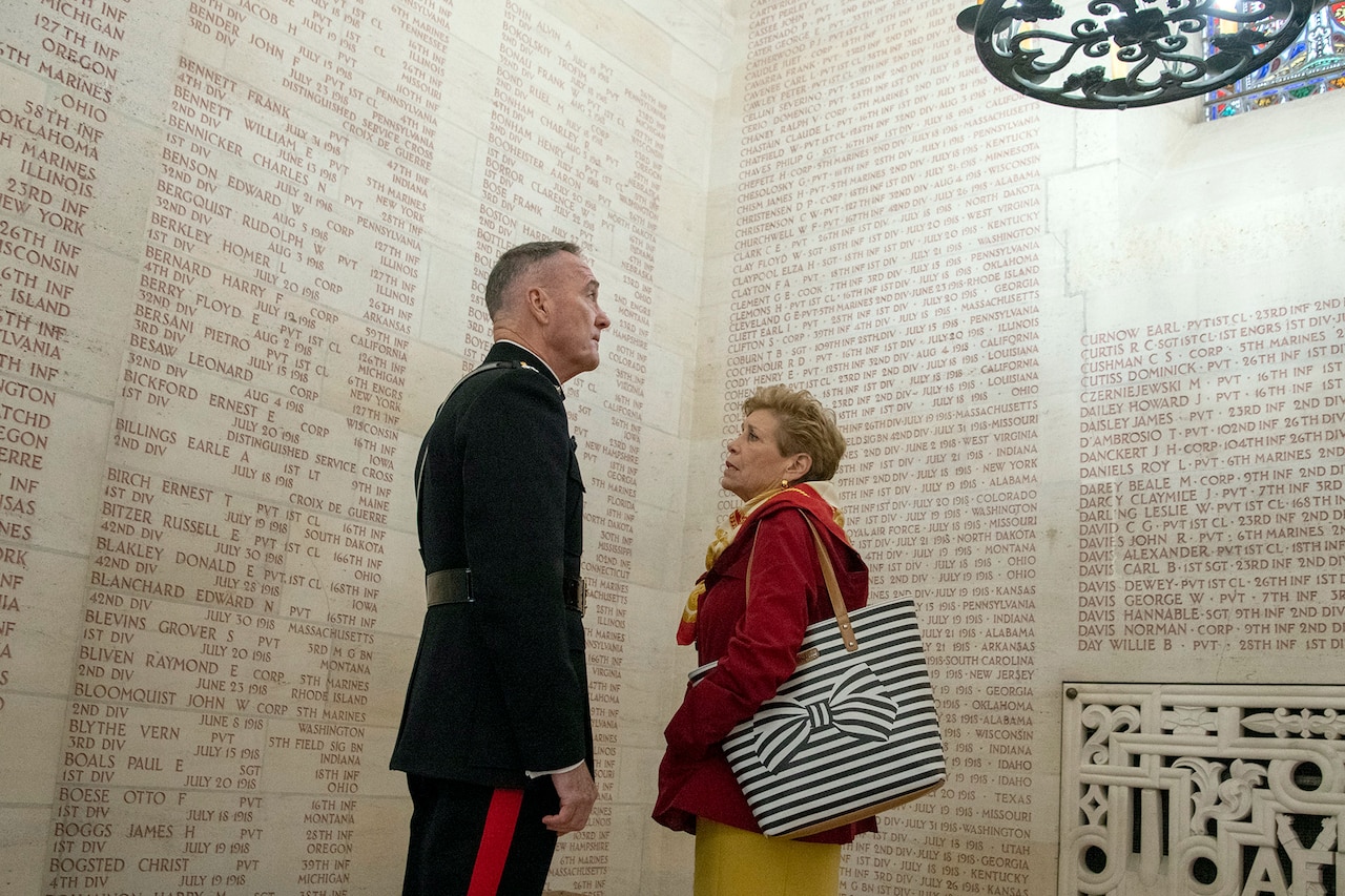 Marine Corps Gen. Joe Dunford, chairman of the Joint Chiefs of Staff, and his wife, Ellyn, read names on a wall in a chapel.