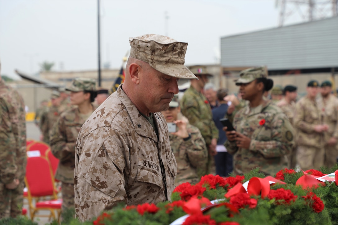 An Army general pauses to look at a wreath during a Veterans Day ceremony