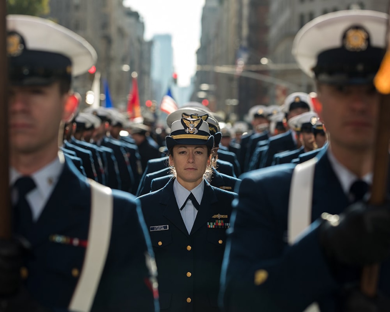 A group of service members march in a parade.