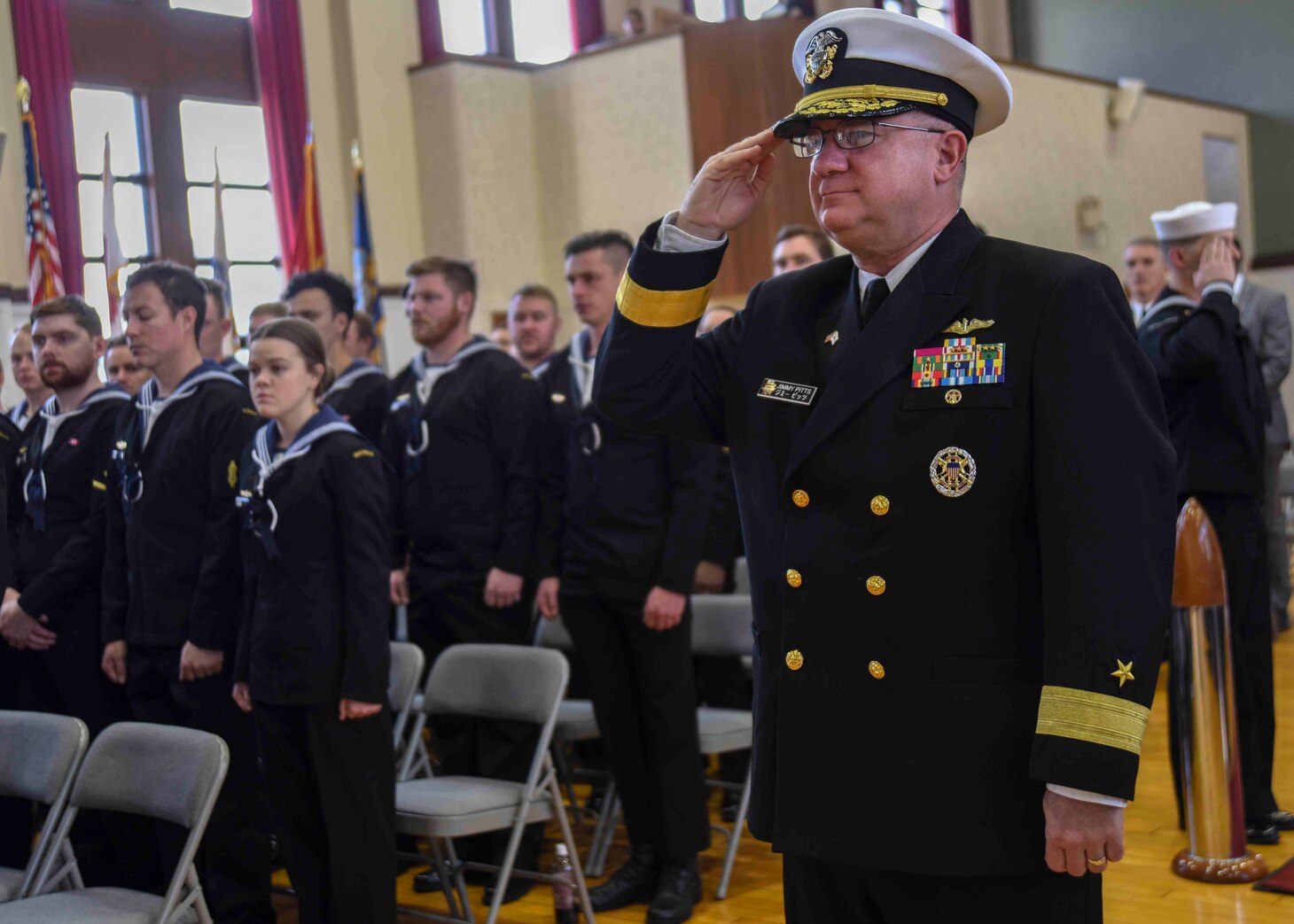 FLEET ACTIVITIES YOKOSUKA, Japan (Nov. 11, 2018) Rear Adm. Jimmy Pitts, Commander, Submarine Group 7, salutes during the national anthem prior to giving the keynote address at the Fleet Activities Yokosuka "Bells of Peace" memorial event commemorating the 100th Anniversary of the end of World War I. The ceremony, attended by several current and former Sailors on base as well as Japan Maritime Self Defense Force, Royal Canadian Navy and Royal Australian Navy Sailors, was one of more than 60 held worldwide.