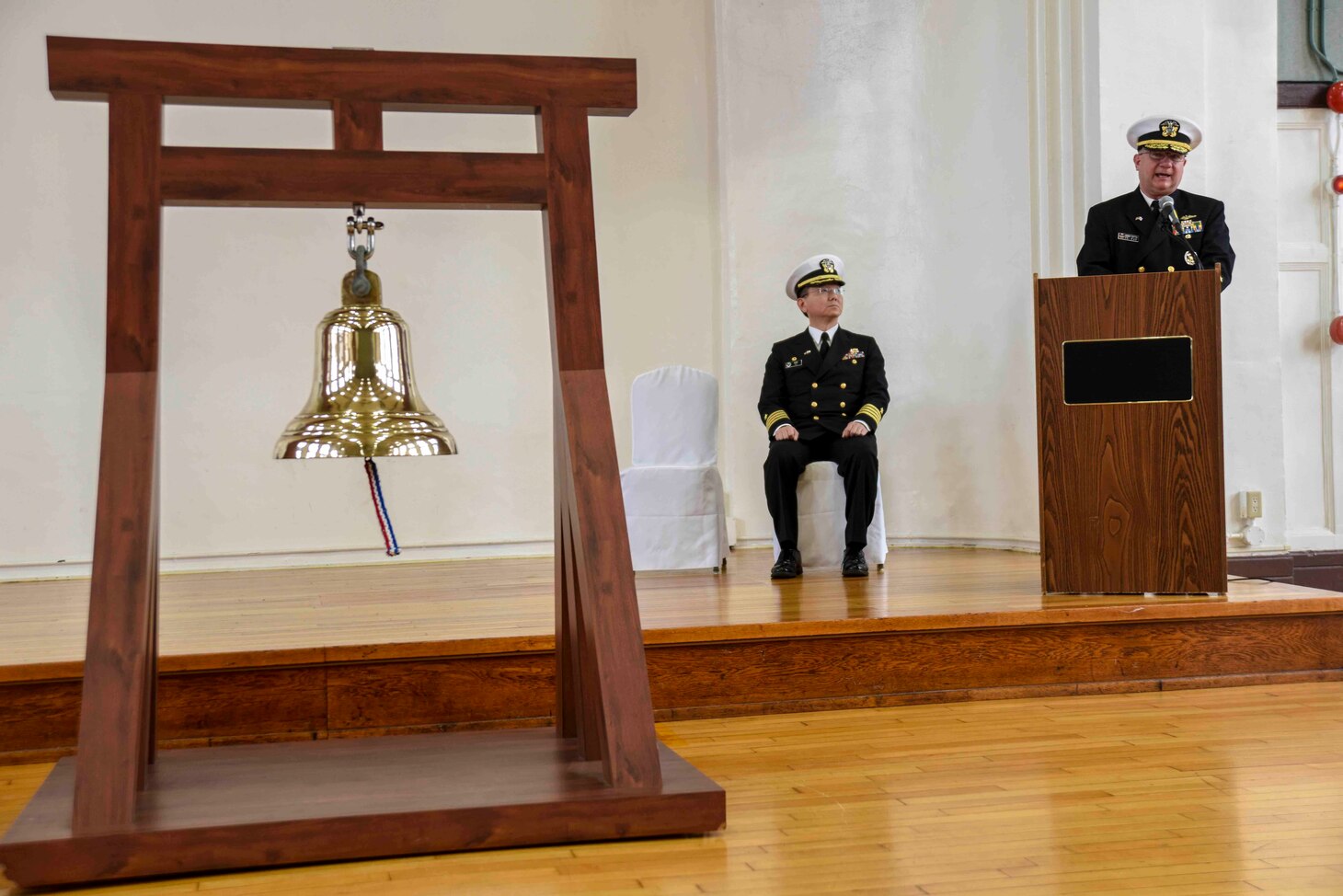 FLEET ACTIVITIES YOKOSUKA, Japan (Nov. 11, 2018) Rear Adm. Jimmy Pitts, Commander, Submarine Group 7, right, gives the keynote address at the Fleet Activities Yokosuka "Bells of Peace" memorial event commemorating the 100th Anniversary of the end of World War I. The ceremony, attended by several current and former Sailors on base as well as Japan Maritime Self Defense Force, Royal Canadian Navy and Royal Australian Navy Sailors, was one of more than 60 held worldwide.
