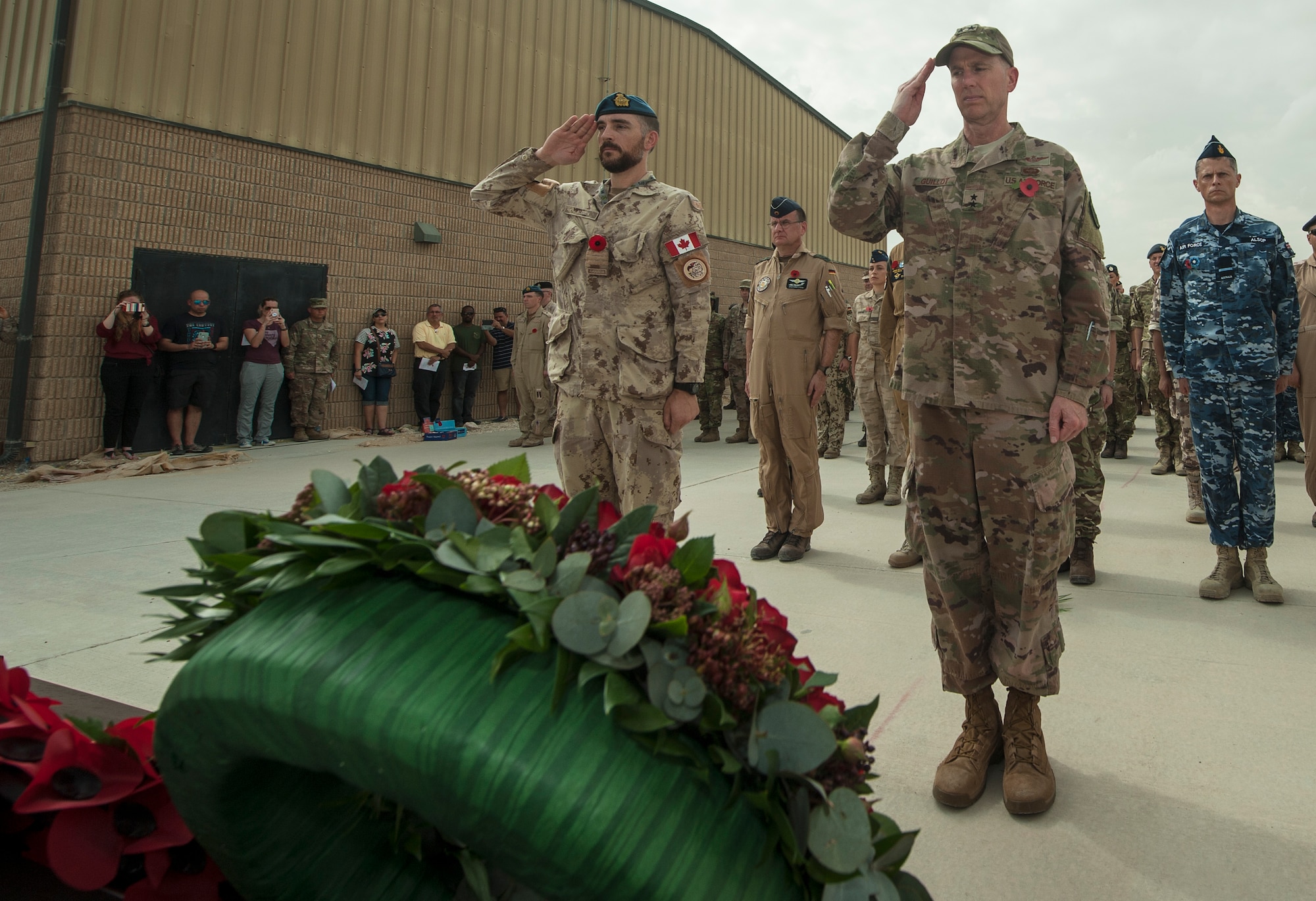 U.S. Air Force Maj. Gen. Gregory Guillot, right, U.S. Air Forces Central Command deputy combined force air component commander, renders a salute alongside coalition leaders to honor the fallen during a Service of Remembrance Nov. 11, 2018, at Al Udeid Air Base, Qatar. Members of the Royal Air Force hosted the event, organizing the involvement of 15 nations’ military members. The service marked 100 years since the end of World War I. (U.S. Air Force photo by Tech. Sgt. Christopher Hubenthal)